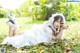 A woman in a white dress laying on the ground.