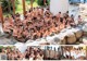 A group of naked women posing for a picture in a hot spring.